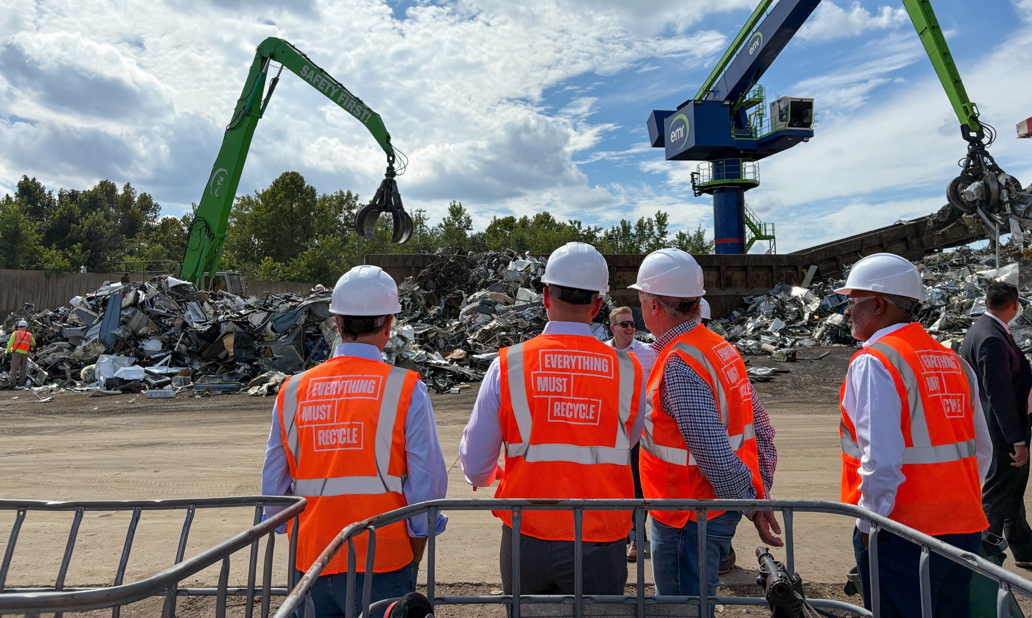 A picture of Congressman Norcross, Camden Mayor Carstarphen, Congressman Frank Pallone, and the EMR CEO observing operations at the EMR scrap metal recycling facility