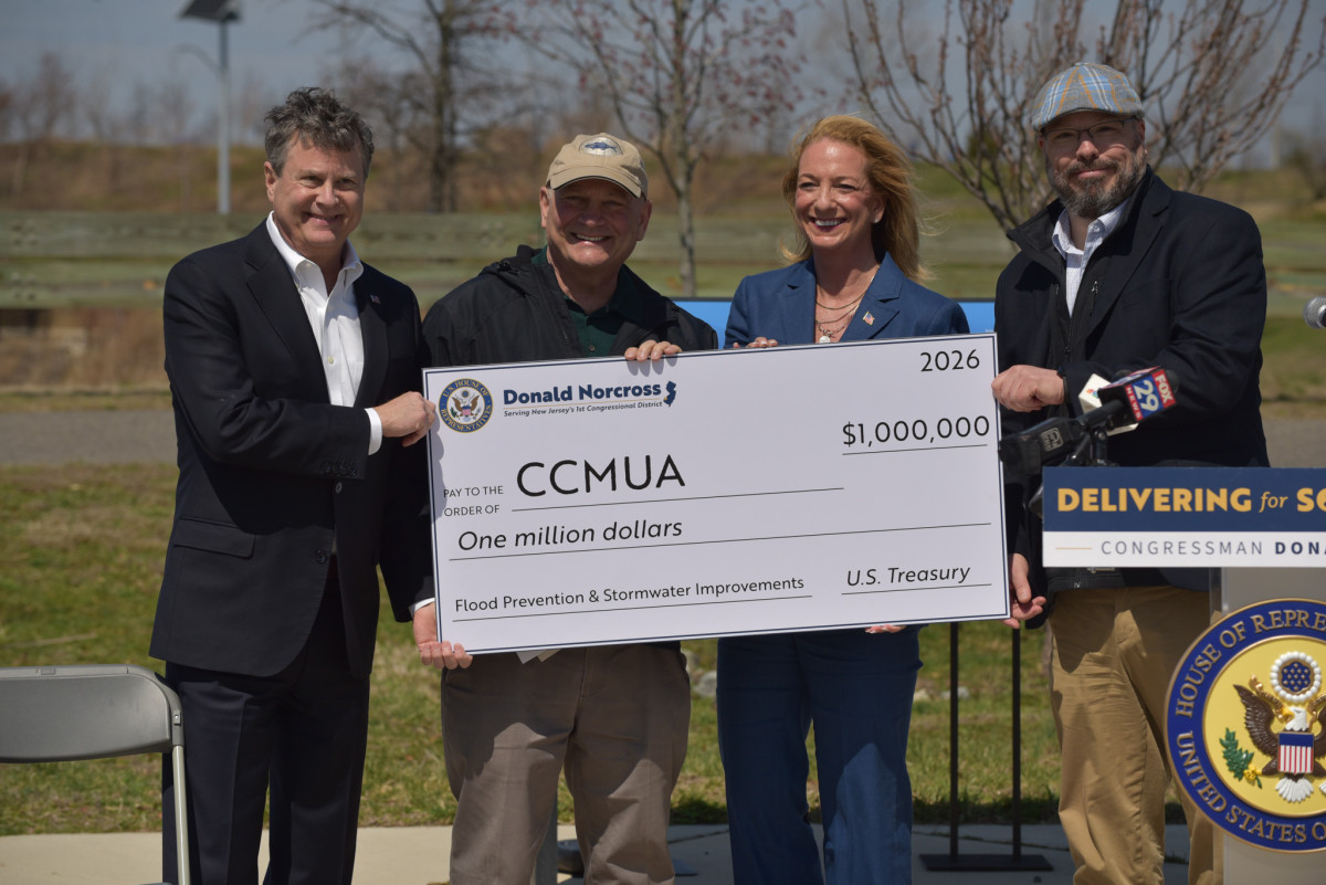 Congressman Norcross hands a large check for federal funding to staff from the Camden County Municipal Utilities Authority and Camden County Board of Commissioners Jeff Nash and Jennifer Cooley-Fleisher