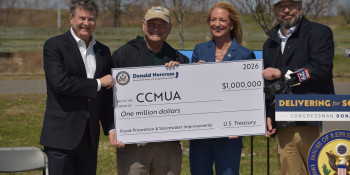Congressman Norcross hands a large check for federal funding to staff from the Camden County Municipal Utilities Authority and Camden County Board of Commissioners Jeff Nash and Jennifer Cooley-Fleisher